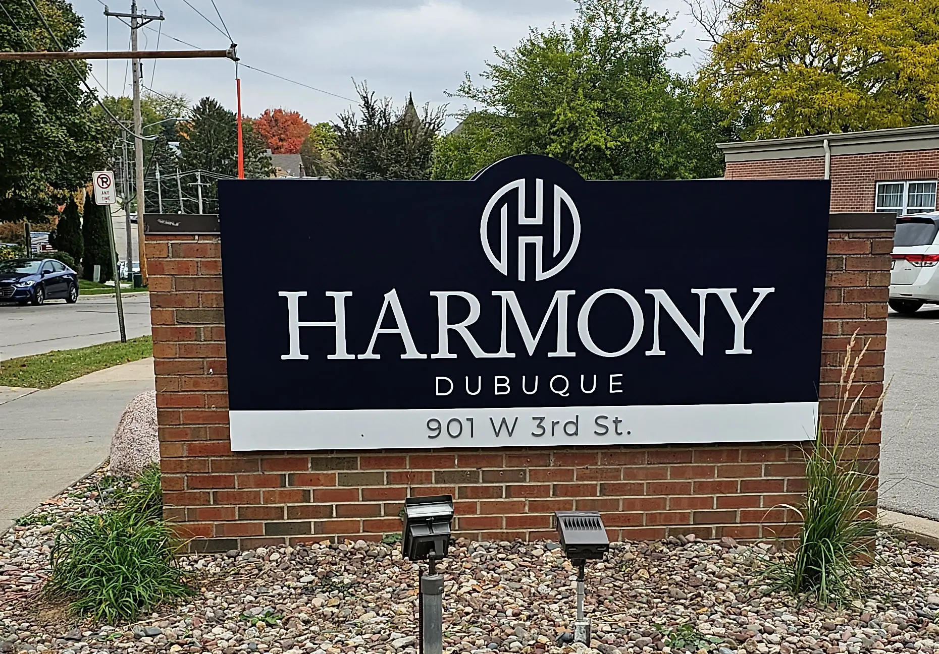 A brick sign with a black background displays the word 