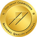 Gold circular badge with a stylized 